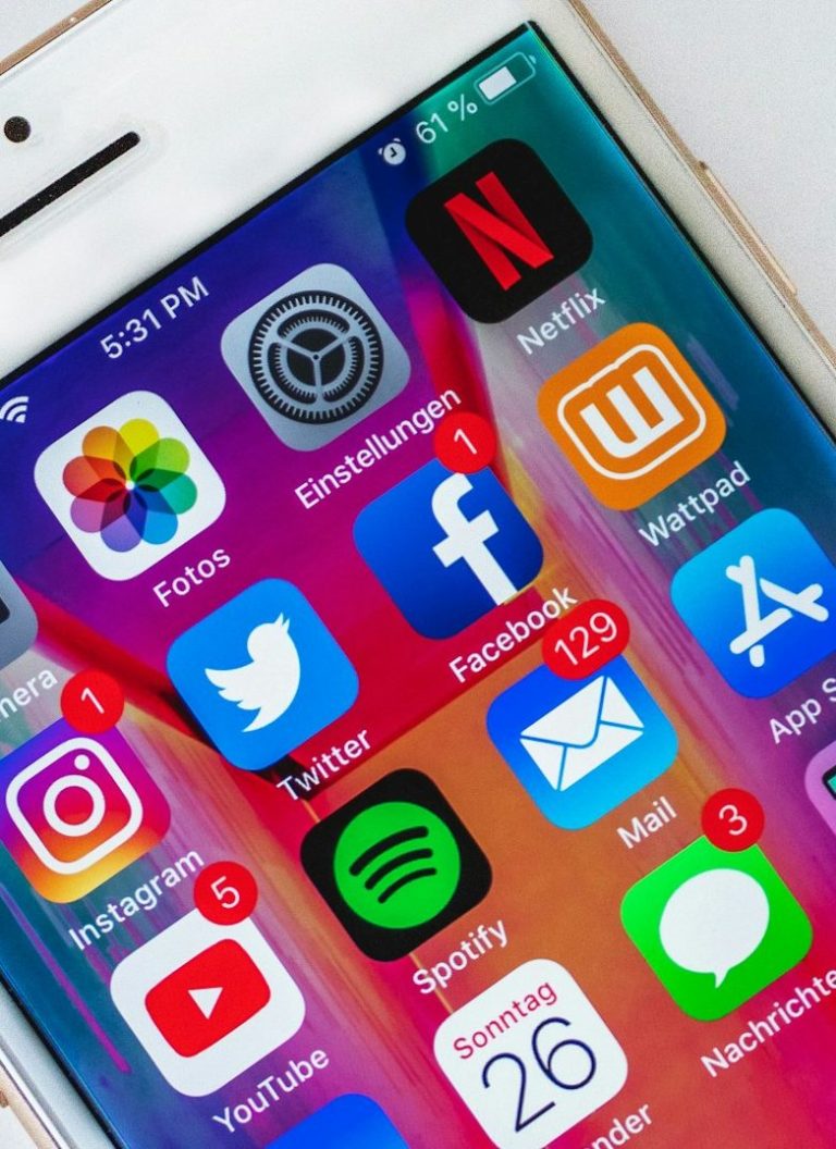Close-up of a smartphone screen displaying various app icons, including social media and streaming services.