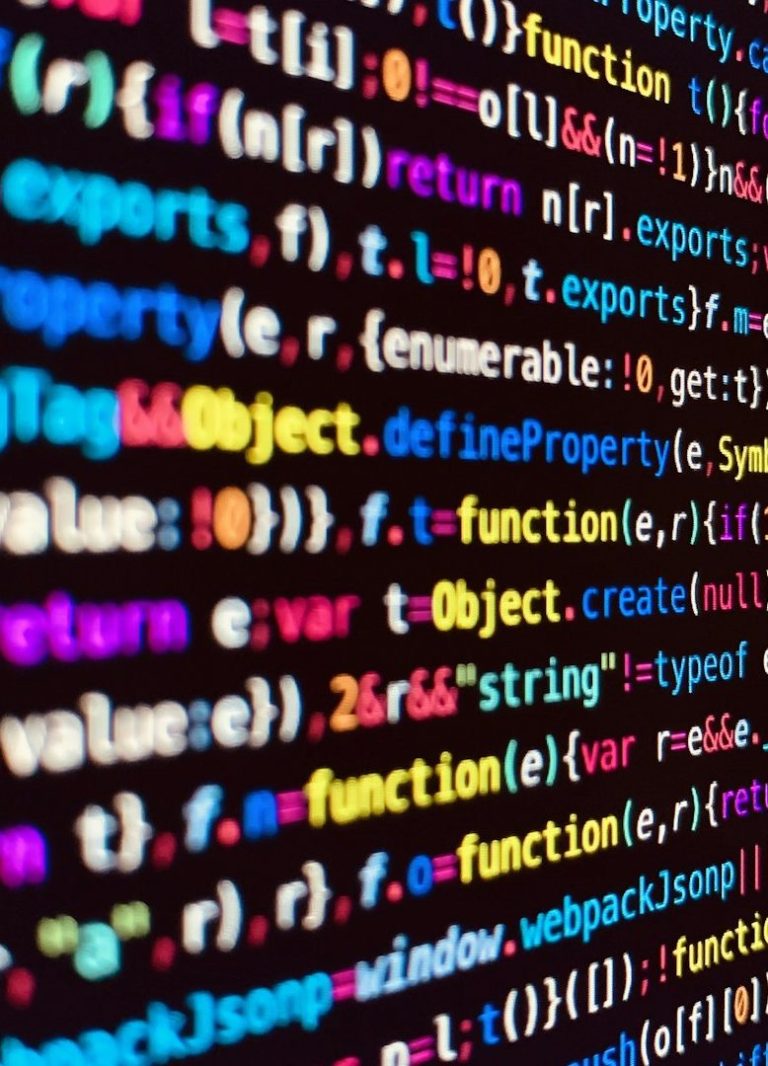 Computer Programming Code Colorful computer code on a dark background.