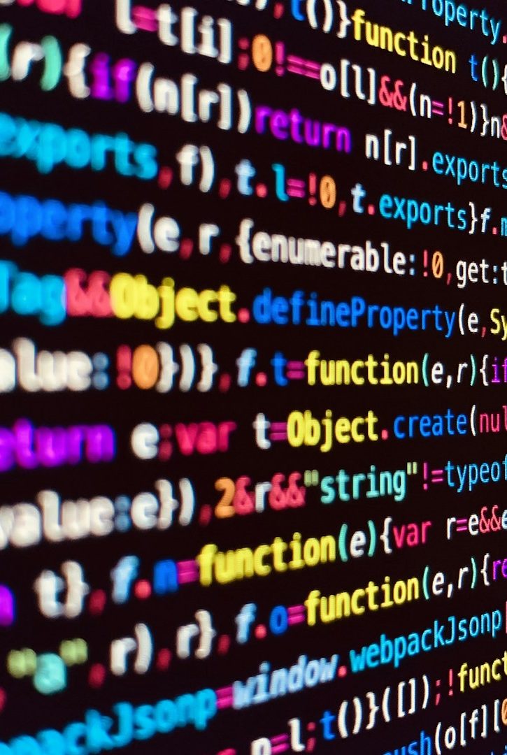 Computer Programming Code Colorful computer code on a dark background.